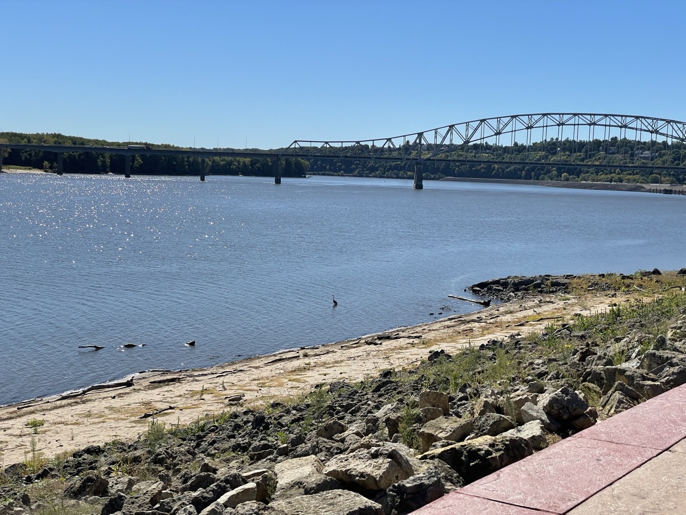 The Mississippi River and a steel bridge near Dubuque, Iowa, on a bright clear day.